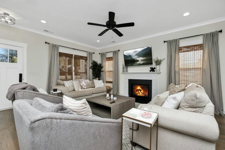 a living room filled with furniture and a ceiling fan