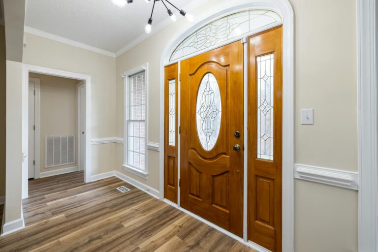 Bright entrance with a wooden door and glass panels showcasing modern interior design elements. 3 Way Switch