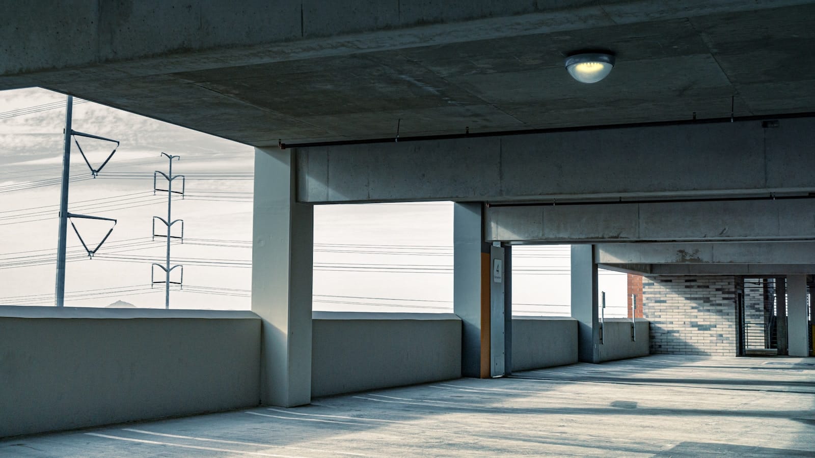 an empty parking garage with a sign on the wall